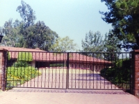 iron-anvil-gates-by-others-driveway-scrolls-a