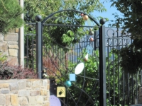 iron-anvil-gates-by-others-man-arch-top-modern-design