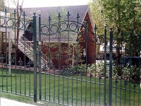 iron-anvil-gates-man-arch-dog-guard-and-circles-at-the-top
