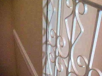 iron-anvil-railing-scrolls-and-patterns-repeating-steel-patterns-white-railing-by-others-1-2
