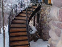 41-0040-iron-anvil-stairs-grand-circular-treads-angle-iron-wood-steps-park-city-1