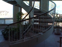 41-0050-iron-anvil-stairs-grand-circular-treads-angle-iron-wood-treads-jensen-wally-stair-saratoga-springs-1