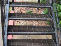 iron-anvil-stairs-double-stringer-treads-bar-grate-apartment-off-holiday-blvd-by-others